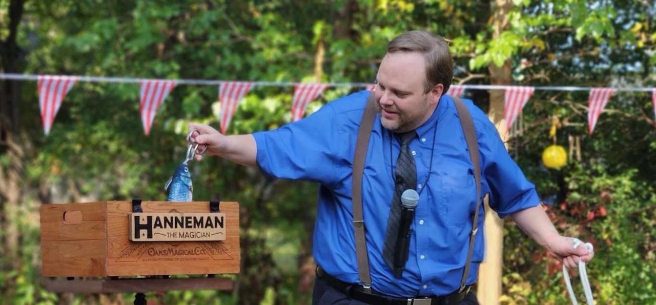 Hanneman the Magician playing tug of war with Muffin the Wonder-Fish outdoors