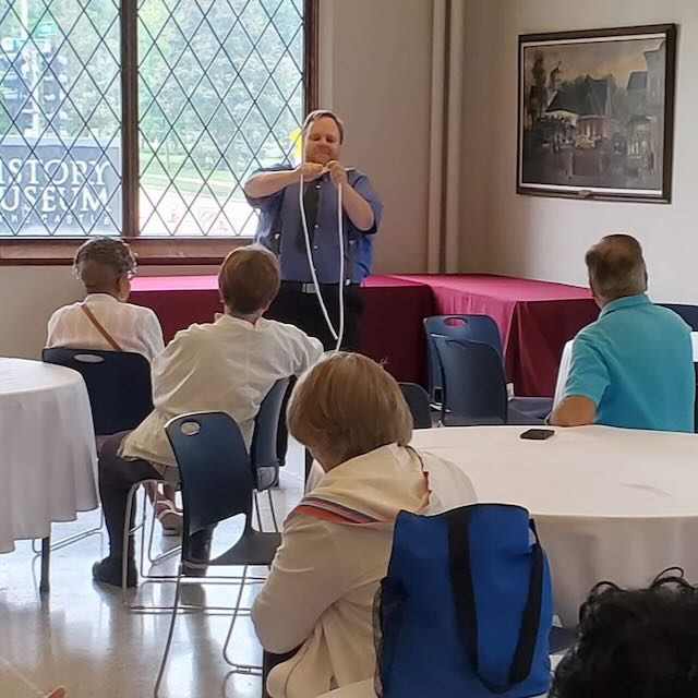 Hanneman performing a rope routine for a seated indoor group
